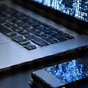 A compact, high-performance portable SSD (Solid State Drive) connected to a sleek laptop, surrounded by digital data flow visual effects. The background is dark and futuristic. No text.